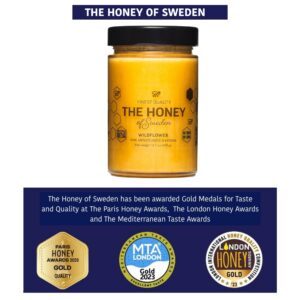 Jar of award-winning wildflower honey from The Honey of Sweden, showcasing gold medals for taste and quality.